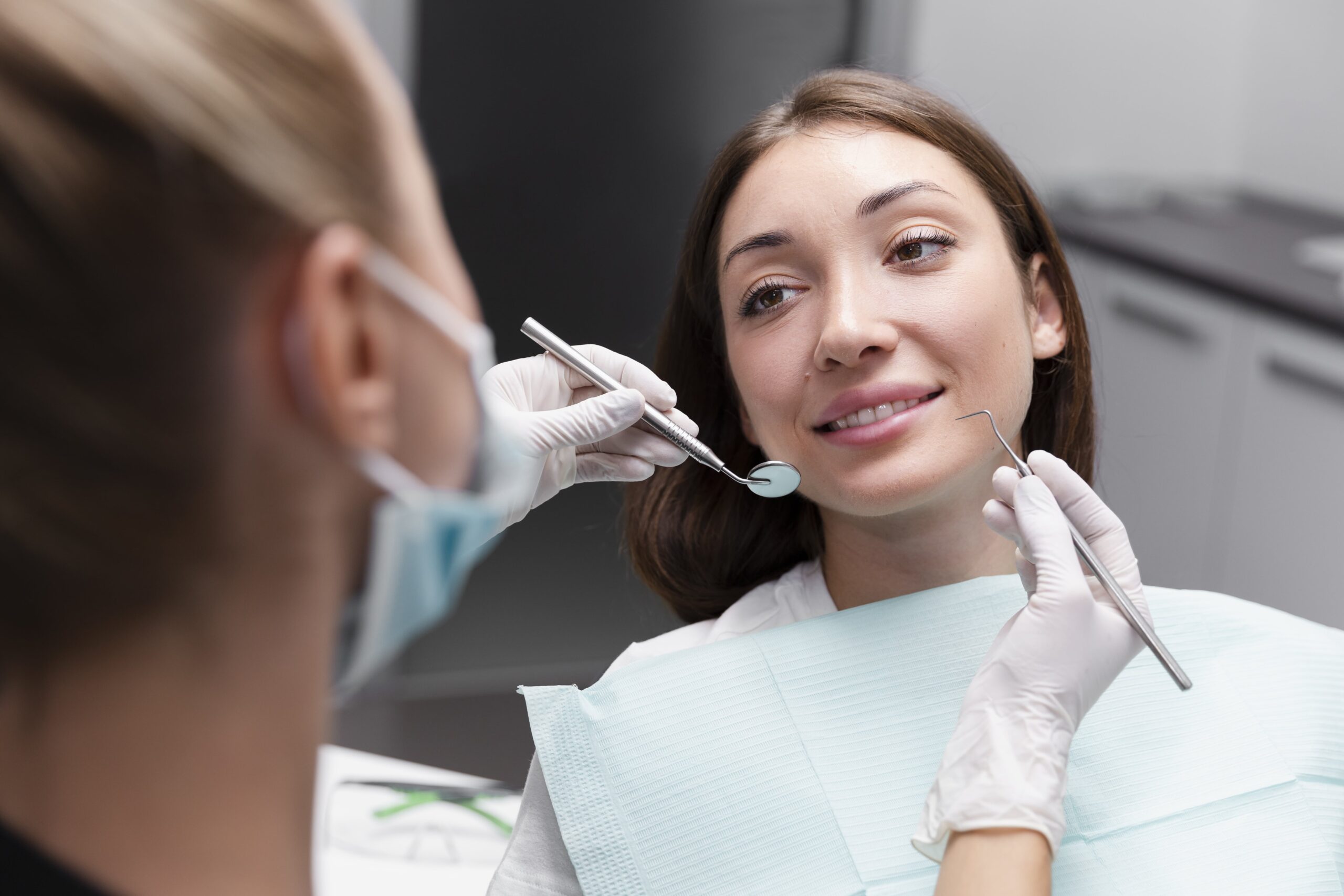 close-up-smiley-patient-dentist-appointment-min